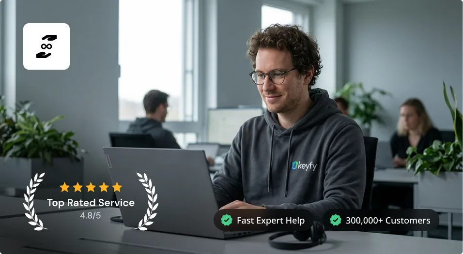 A man with curly hair and glasses works on a laptop in a modern office. He wears an Okefy hoodie. Icons highlight top-rated service, fast expert help, and over 300,000 customers. Other people work in the background.